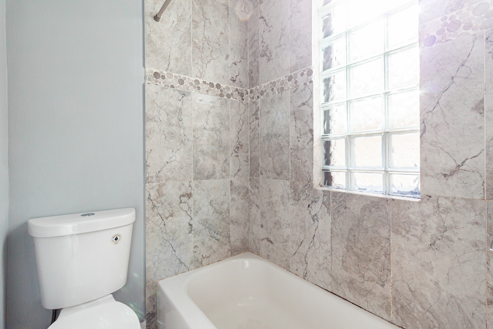 2968 North Ridgeway Avenue, Unit 2R Chicago, IL 60618 - Photo 9 of 23 a bathroom with a toilet and a window