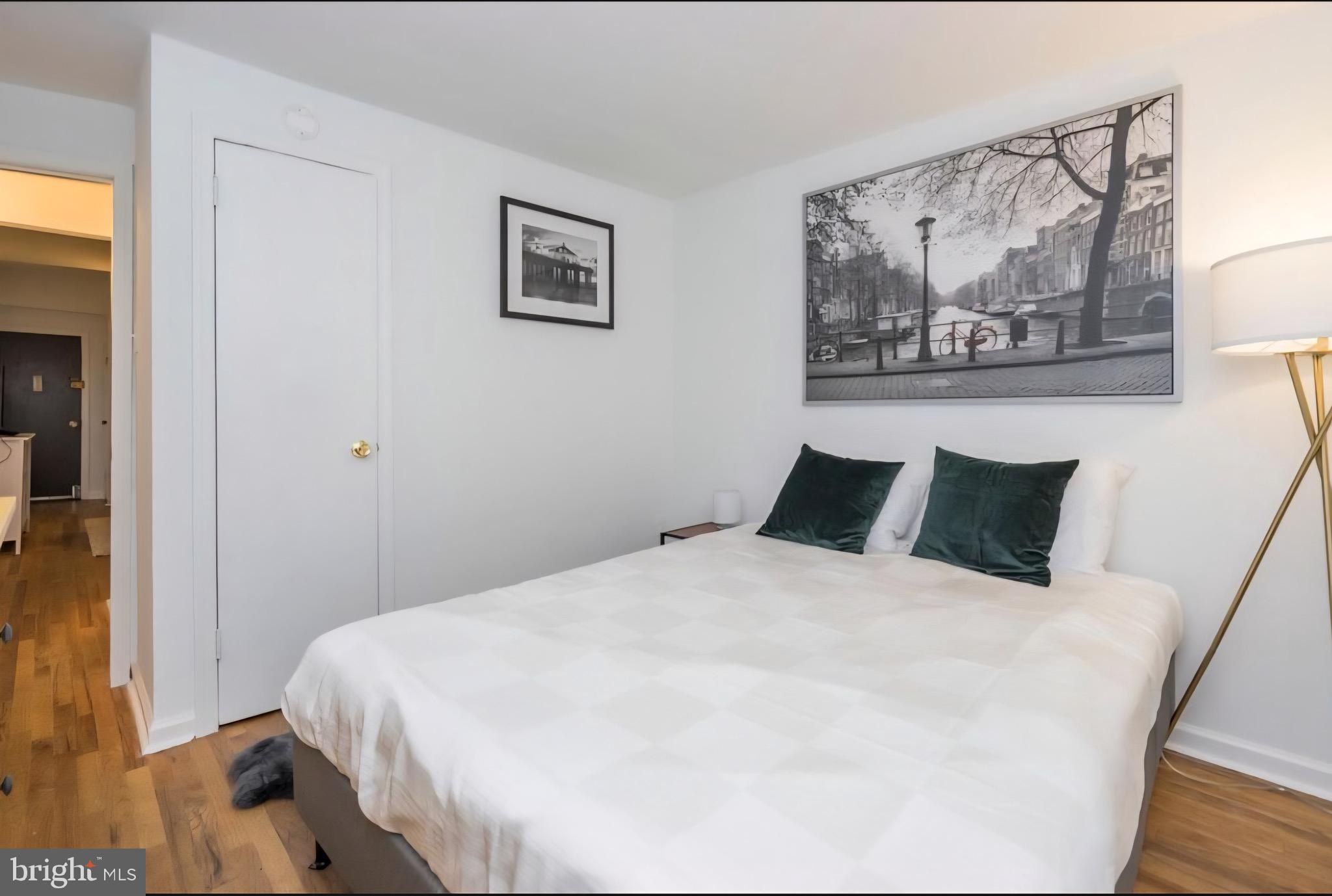 1413 Lombard Street, Unit 2R Philadelphia, PA 19146 - Photo 11 of 15 a large bed in a bedroom next to a small yard