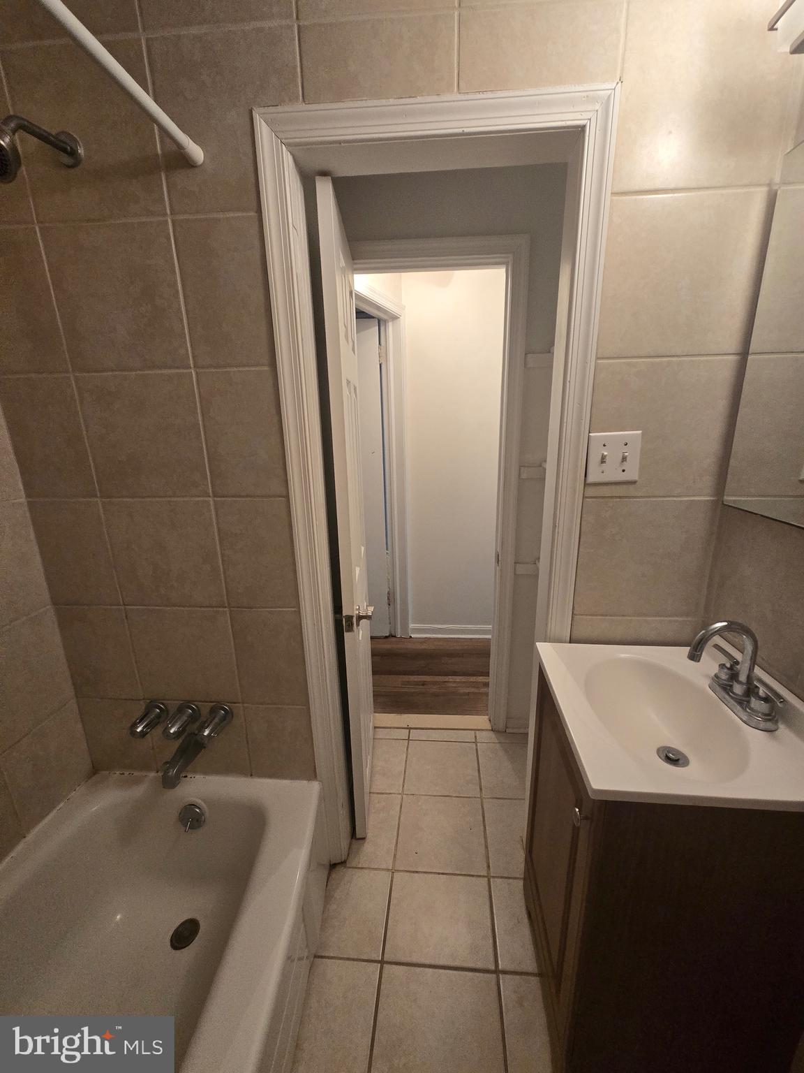 1413 Lombard Street, Unit 2R Philadelphia, PA 19146 - Photo 14 of 15 a bathroom with a bathtub a sink a toilet and a mirror