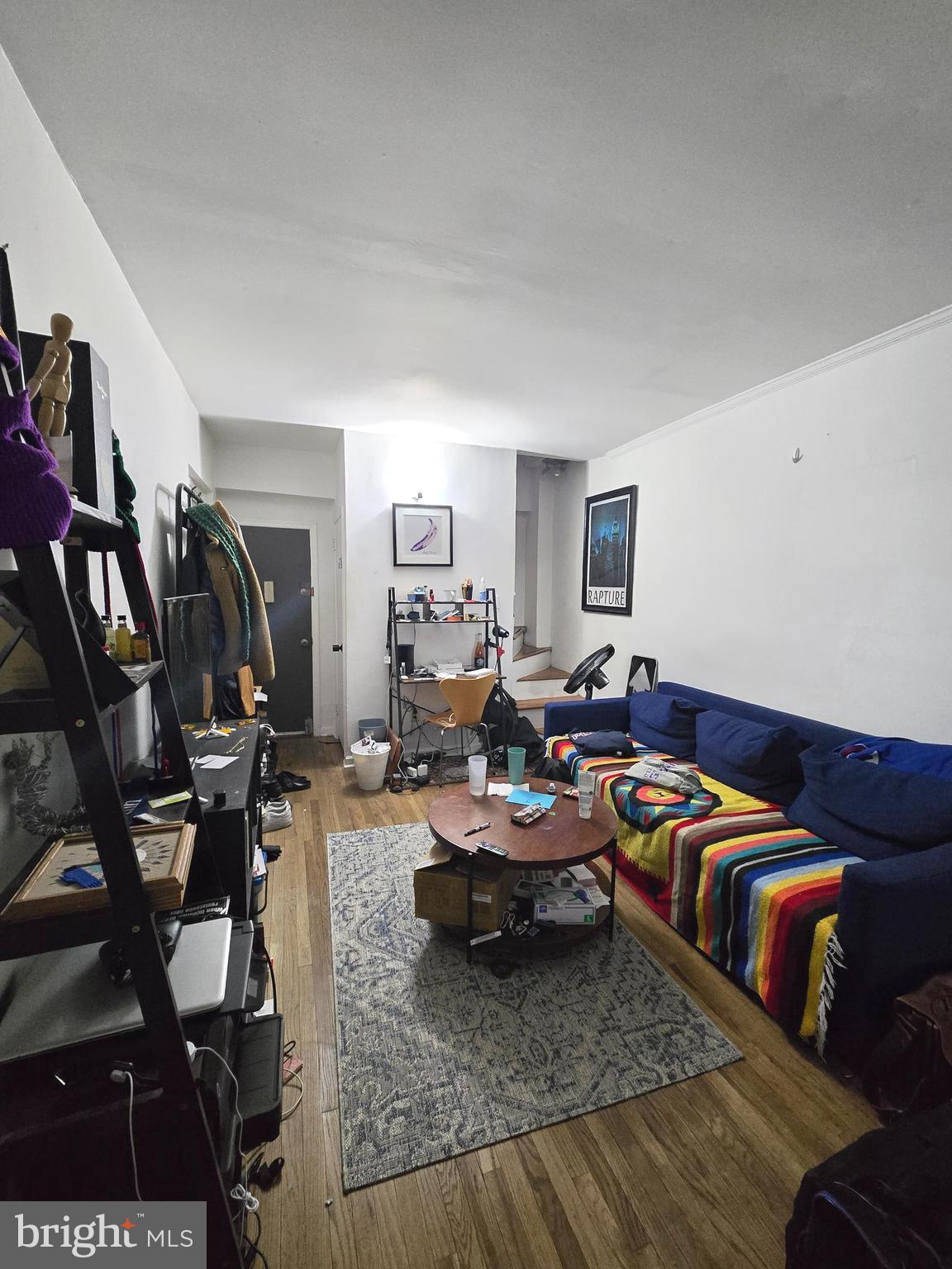1413 Lombard Street, Unit 2R Philadelphia, PA 19146 - Photo 2 of 14 a living room with furniture a rug and gym equipment