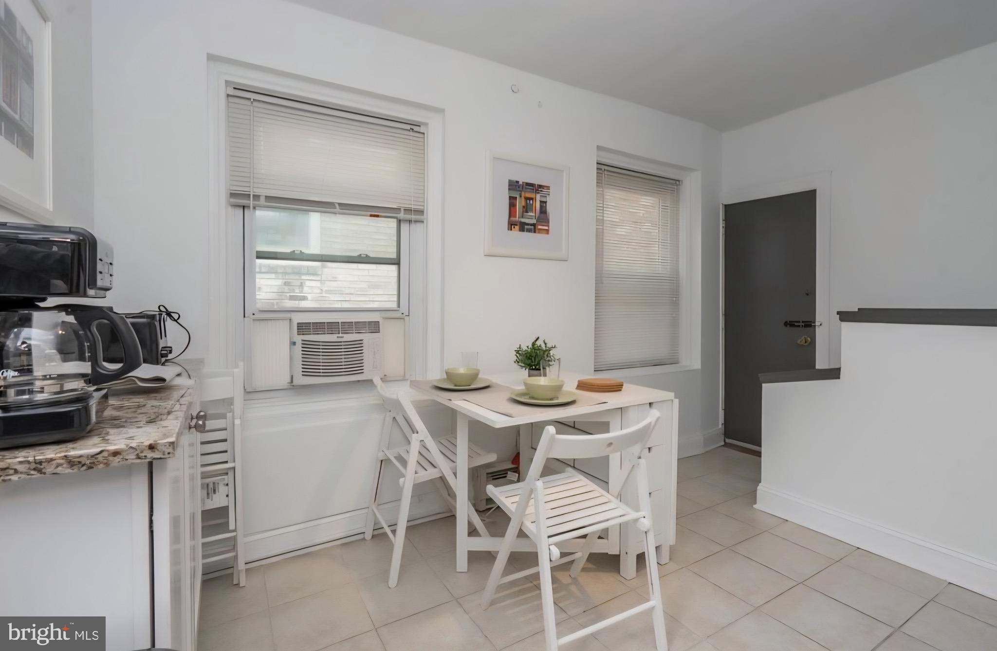 1413 Lombard Street, Unit 2R Philadelphia, PA 19146 - Photo 5 of 15 a view of a dining room with furniture and window