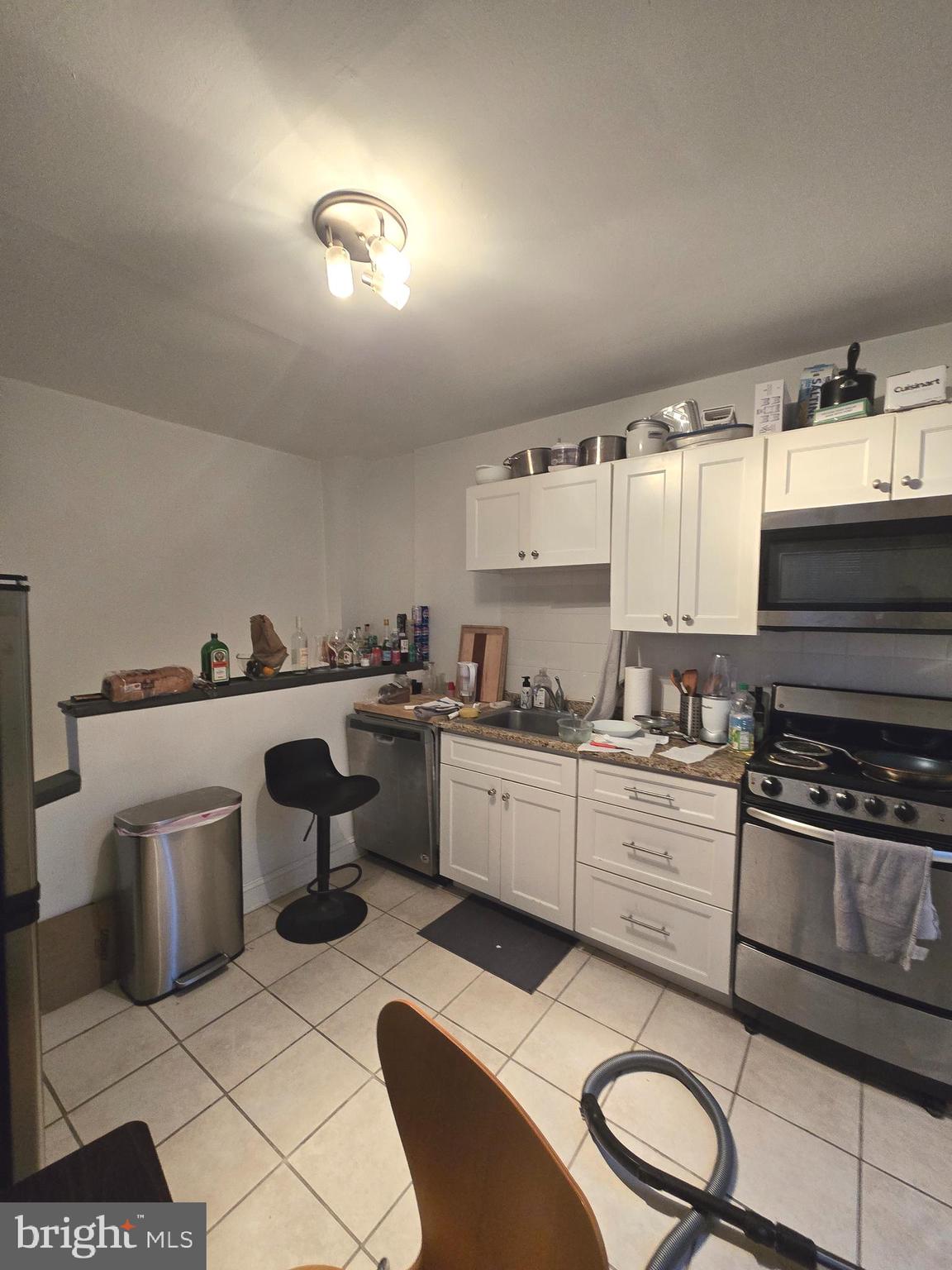 1413 Lombard Street, Unit 2R Philadelphia, PA 19146 - Photo 6 of 14 a kitchen with a sink cabinets and stainless steel appliances