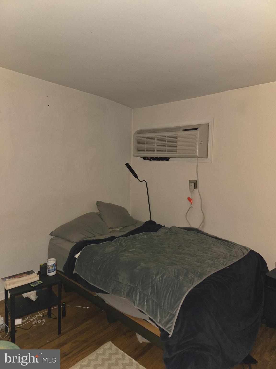 1413 Lombard Street, Unit 2R Philadelphia, PA 19146 - Photo 7 of 14 a bedroom with a bed and lamp