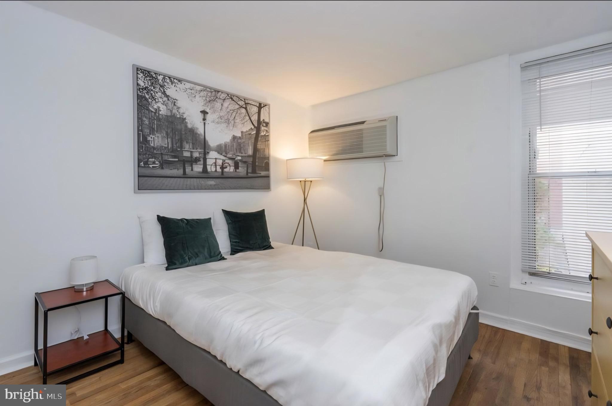 1413 Lombard Street, Unit 2R Philadelphia, PA 19146 - Photo 10 of 15 a bedroom with a bed and a painting on the wall