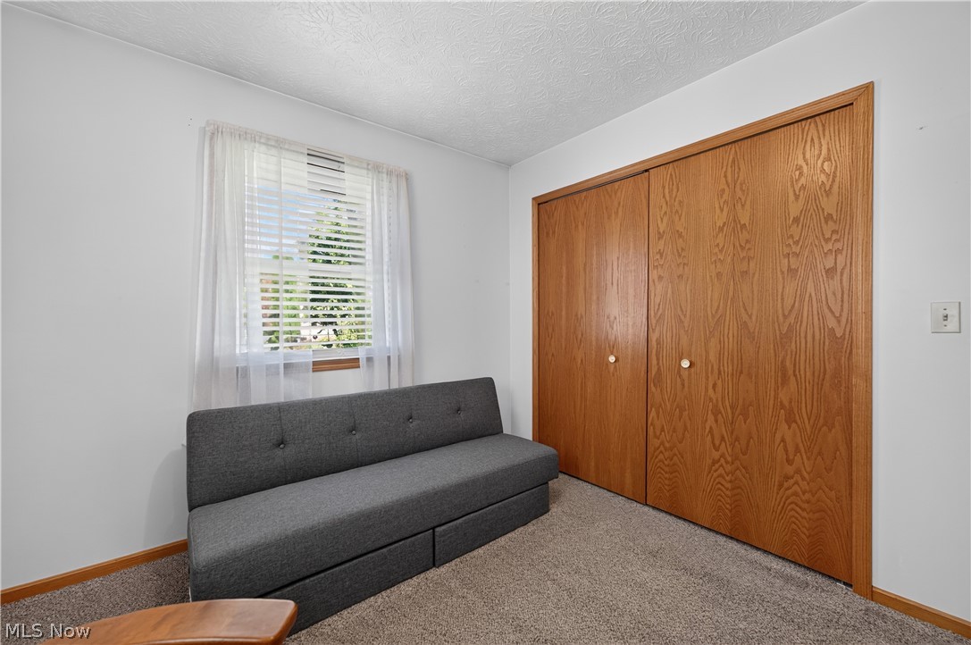 763 Lockwood Road Barberton, OH 44203 - Photo 21 of 24 Carpeted flooring, white painted walls, wood-finish closet doors, window with blinds