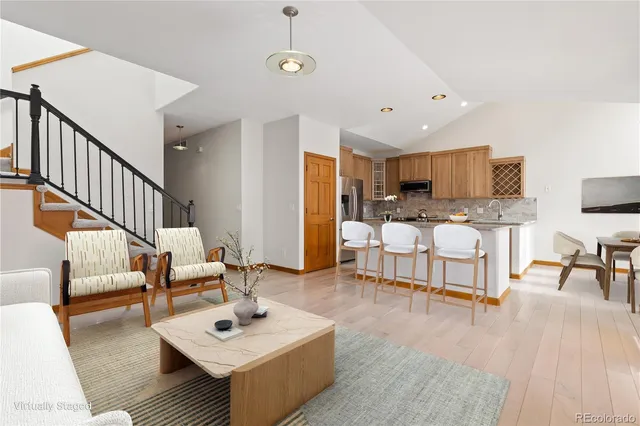 a living room with furniture and kitchen view