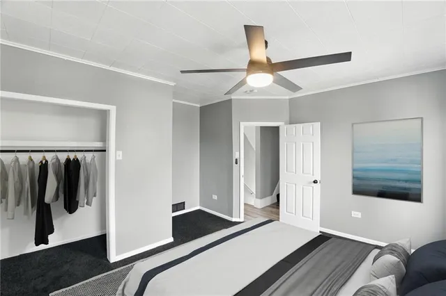 a bedroom with a bed and painting on the wall