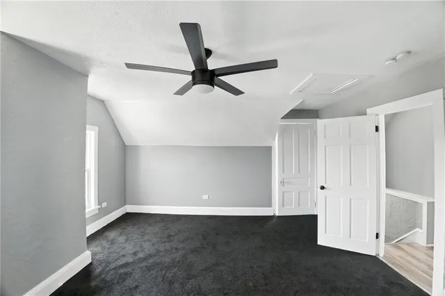 a view of a livingroom with a ceiling fan & window