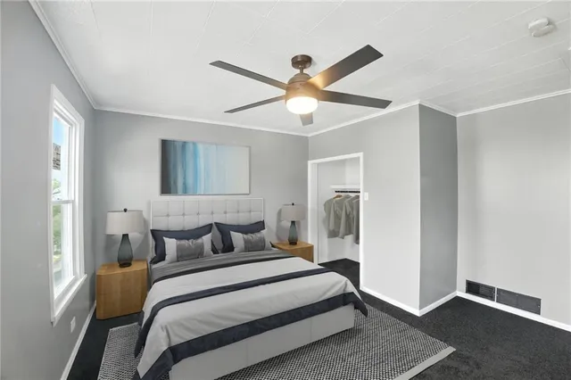 a bedroom with a bed and a ceiling fan