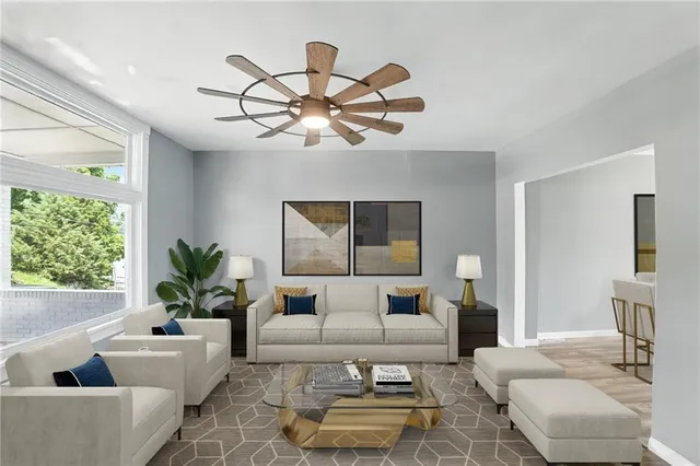 a living room with furniture a chandelier and a rug
