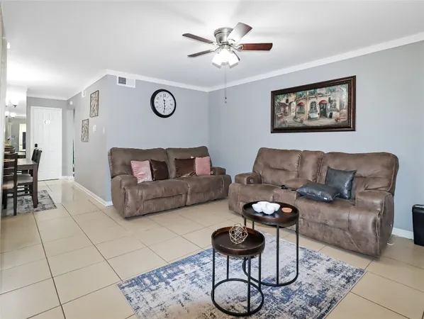 a living room with furniture a clock and a rug