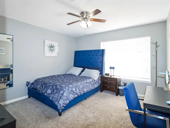 a bedroom with a bed and a desk