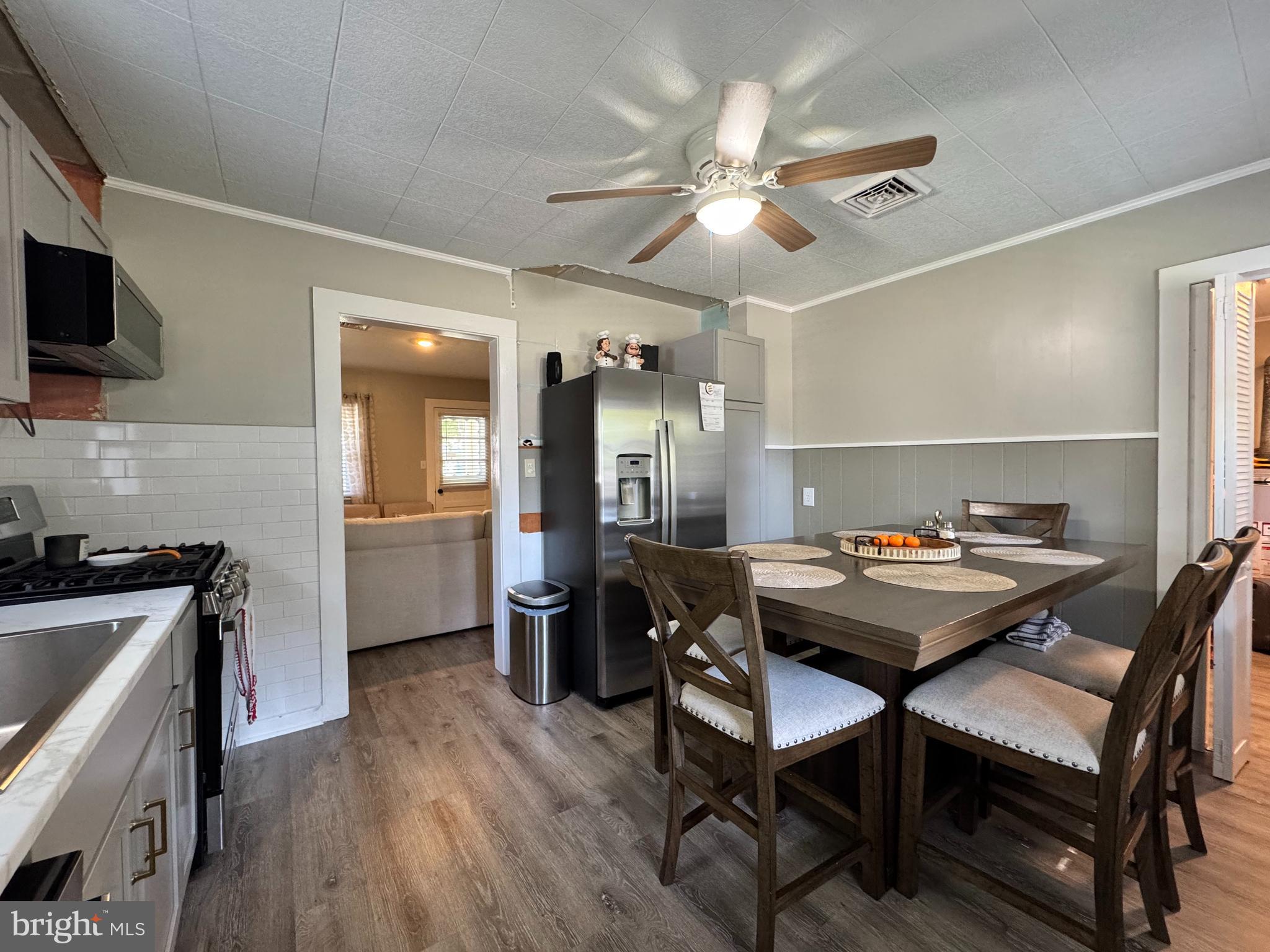30483 Bennett Road Salisbury, MD 21804 - Photo 15 of 46 a kitchen with a dining table and chairs
