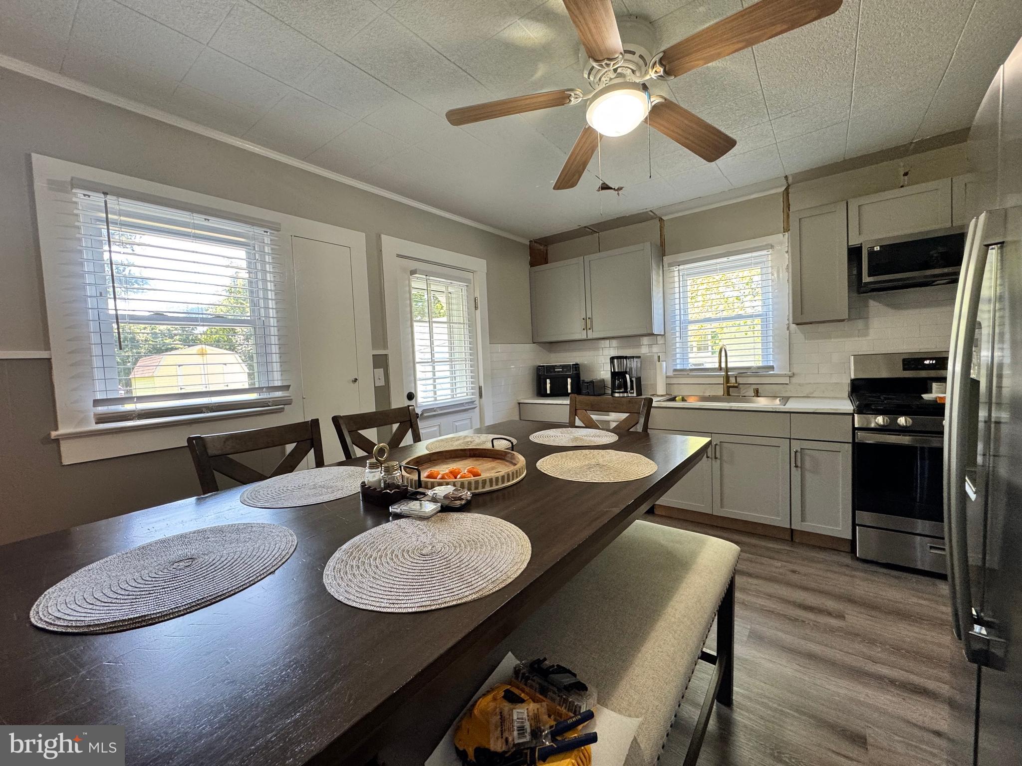 30483 Bennett Road Salisbury, MD 21804 - Photo 17 of 46 a kitchen with granite countertop kitchen island stainless steel appliances sink dining table and chairs