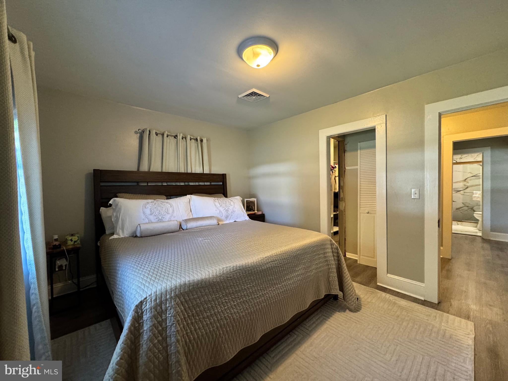 30483 Bennett Road Salisbury, MD 21804 - Photo 21 of 46 a bedroom with a bed and a chandelier