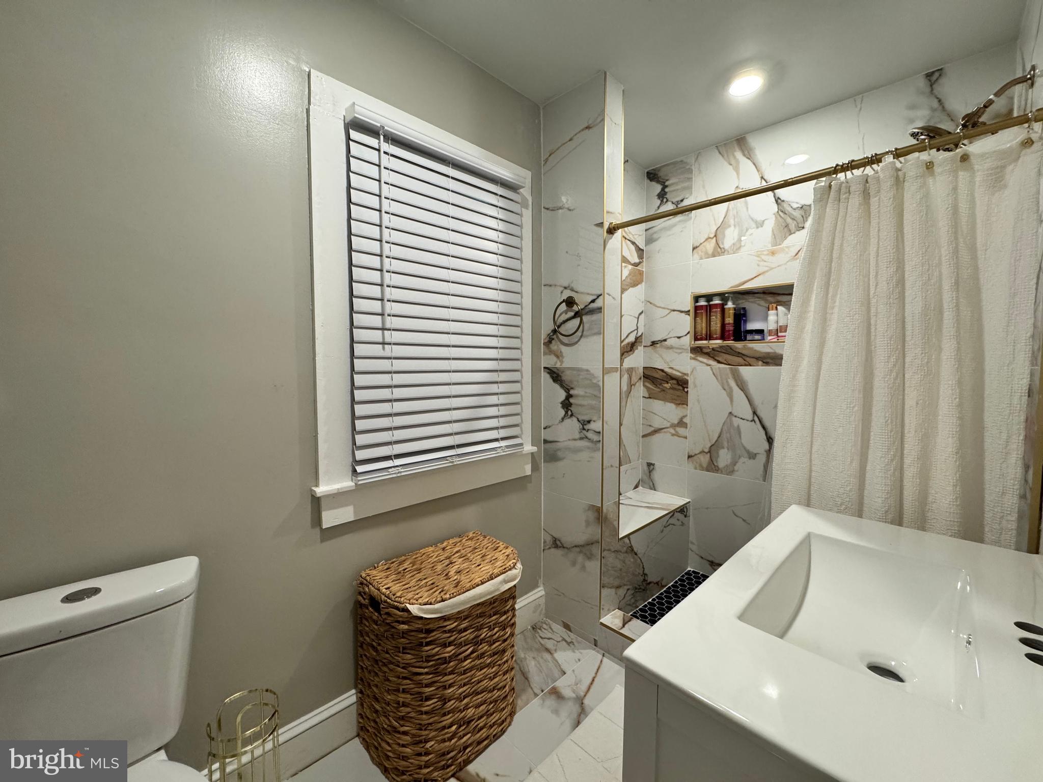 30483 Bennett Road Salisbury, MD 21804 - Photo 25 of 46 a bathroom with a sink and a mirror
