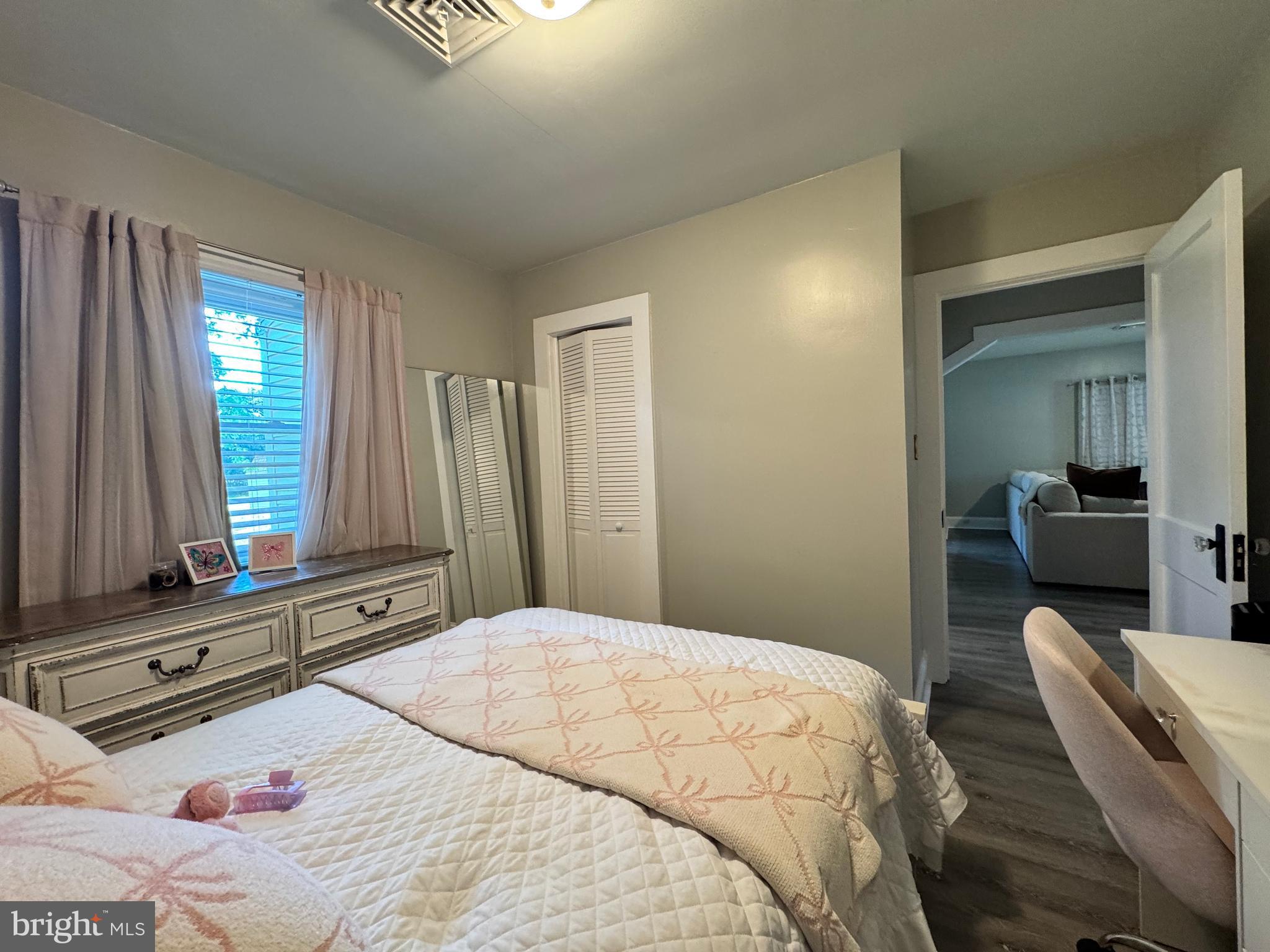 30483 Bennett Road Salisbury, MD 21804 - Photo 29 of 46 a bedroom with a bed and wooden floor