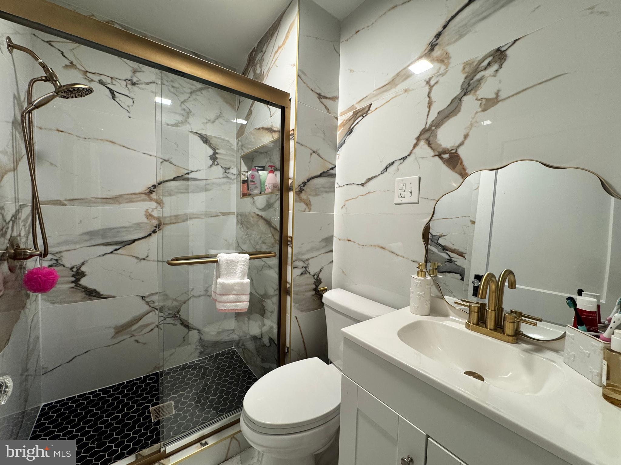 30483 Bennett Road Salisbury, MD 21804 - Photo 30 of 46 a bathroom with a sink toilet and shower