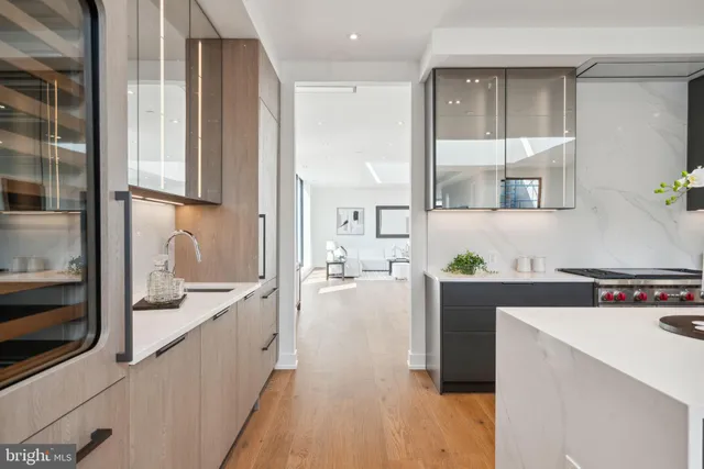 a large kitchen with stainless steel appliances granite countertop a lot of counter space and a sink