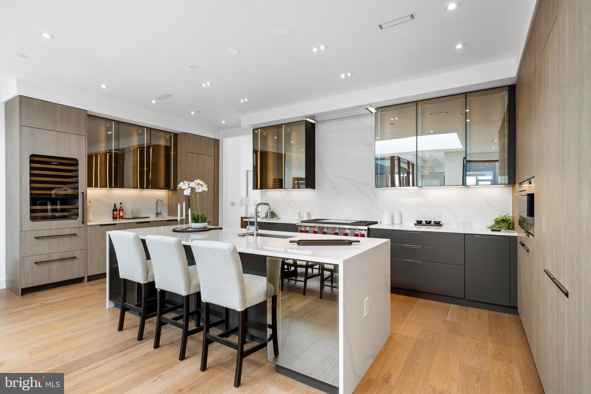 124 North 2nd Street, Unit PH Philadelphia, PA 19106 - Photo 19 of 69 a kitchen with stainless steel appliances granite countertop a stove a sink a refrigerator and chairs