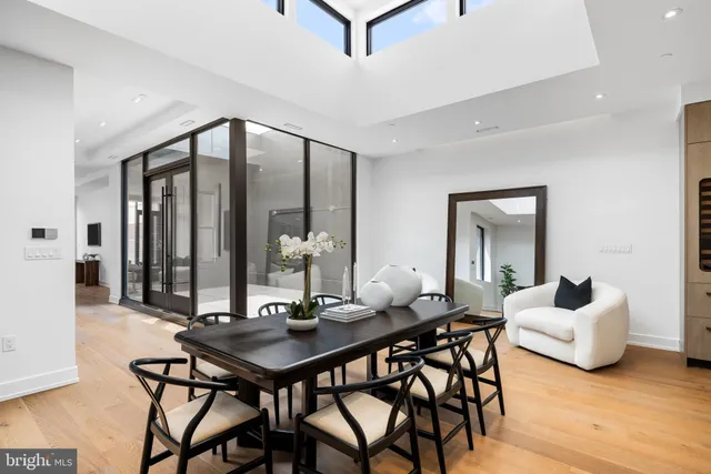 a living room with furniture a flat screen tv and a large window