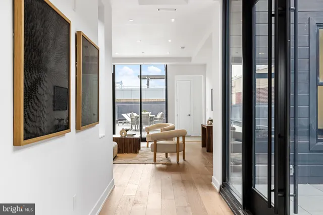 a living room with furniture potted plant and a window
