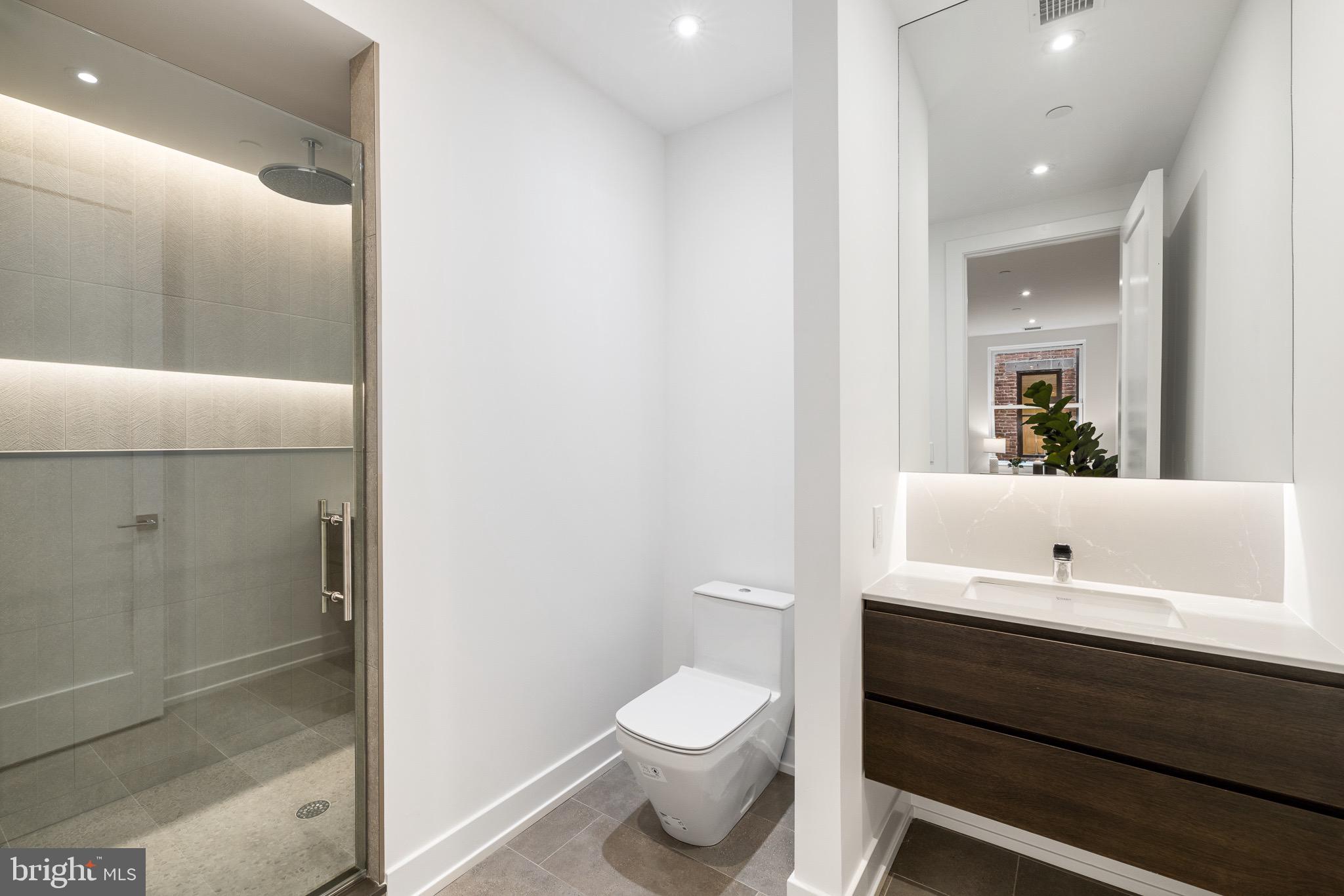 124 North 2nd Street, Unit PH Philadelphia, PA 19106 - Photo 48 of 69 a bathroom with a sink a toilet a shower and a mirror