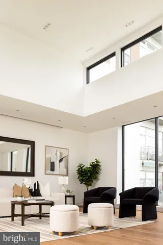 a living room with furniture and large windows