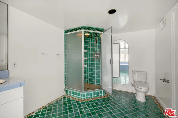 a bathroom with a shower a toilet and a sink