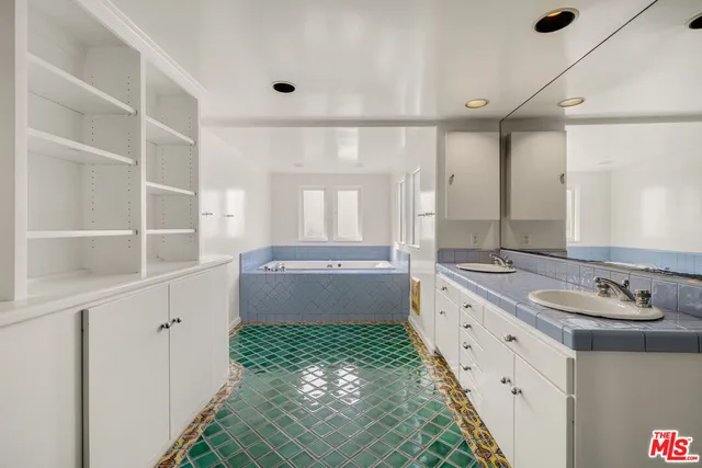 a bathroom with a double vanity sink mirror and double