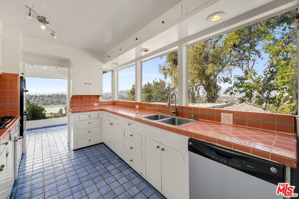 a large kitchen with granite countertop a sink and a window