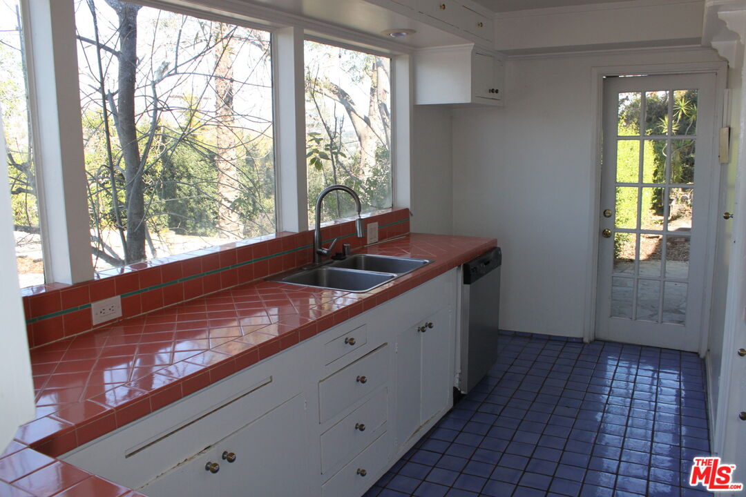 2335 Silver Ridge Avenue Los Angeles, CA 90039 - Photo 6 of 17 a kitchen with a sink window and cabinets