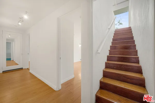 a view of entryway and hall with wooden floor