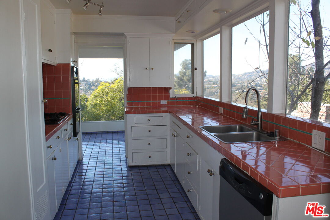 2335 Silver Ridge Avenue Los Angeles, CA 90039 - Photo 8 of 17 a kitchen with granite countertop a sink stove and cabinets