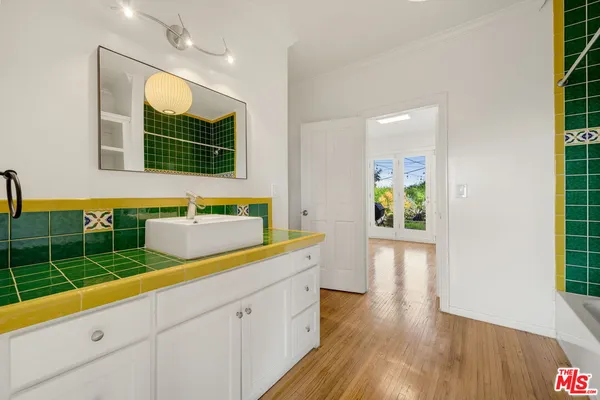a bathroom with a sink a mirror and a bathtub