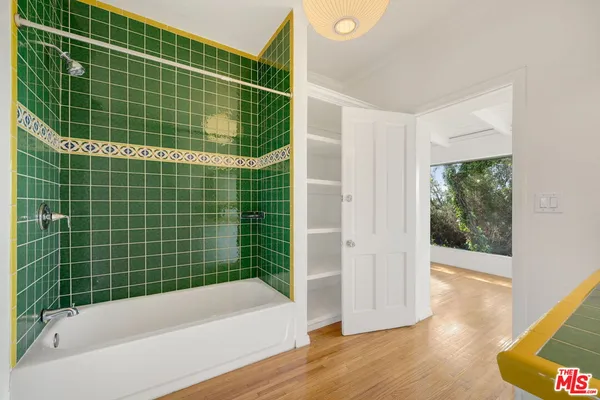 a bathroom with a bathtub and a shower