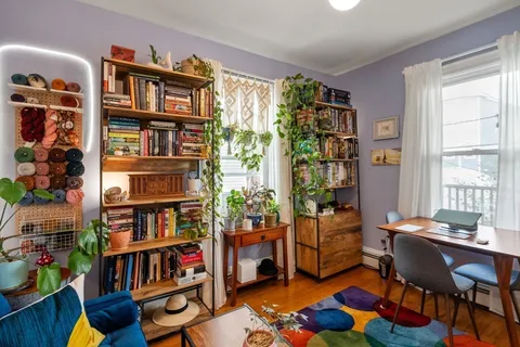 a living room with lots of furniture and a book shelf