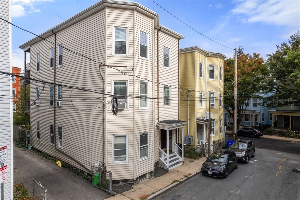 3 Kenney Street, Unit 2 Boston, MA 02130 - Photo 22 of 24 a view of a house with a small yard and large tree