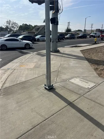a view of parking with cars parked on the roadside