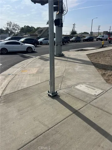 a view of parking with cars parked on the roadside