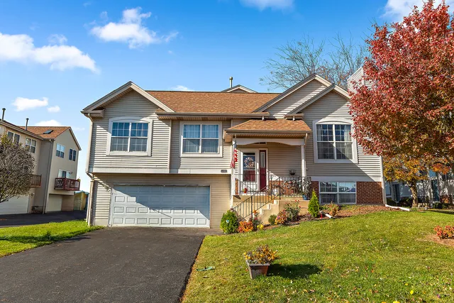 a front view of a house with a garden and yard