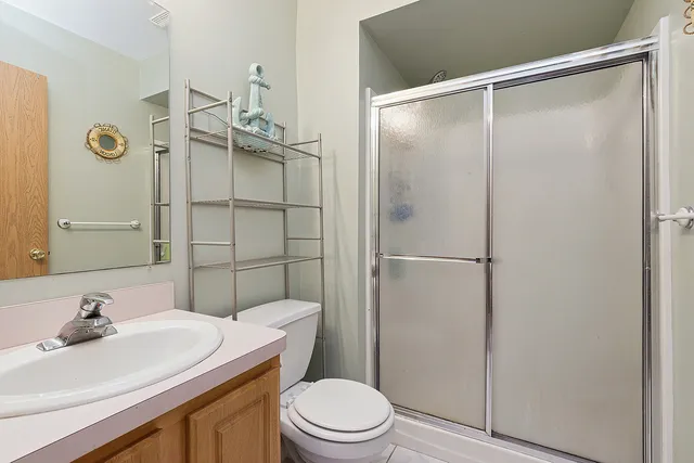 a view of a house with a yard and a large tree