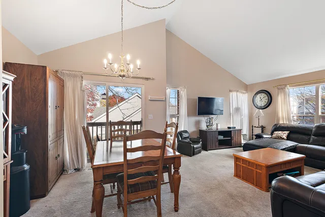 a living room with furniture a large window and a flat screen tv
