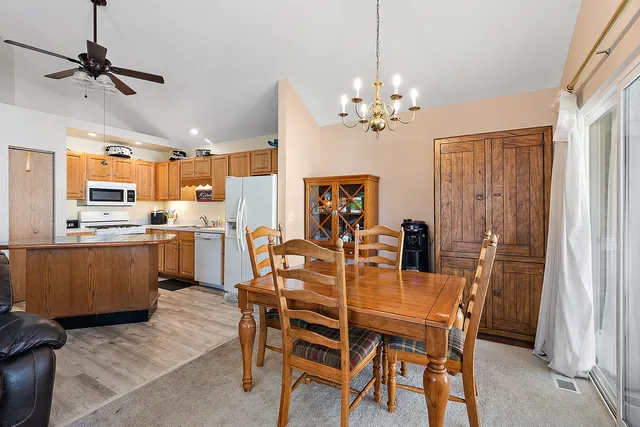 a view of a dining room with furniture and chandelier