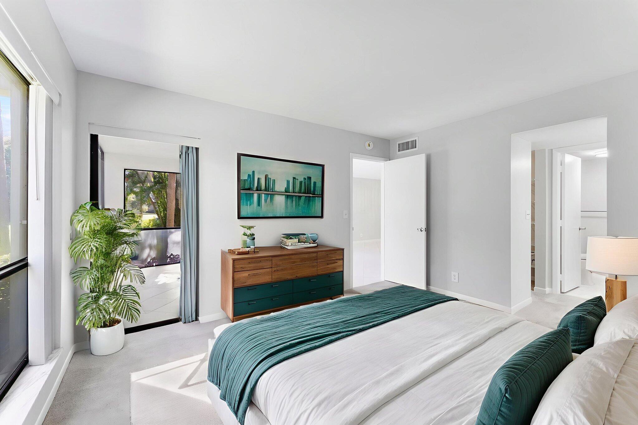 159 Northwest 70th Street, Unit 603 Boca Raton, FL 33487 - Photo 15 of 35 a bedroom with a bed and a potted plant