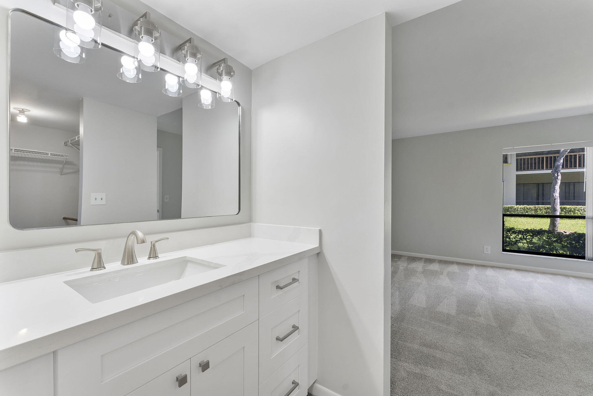 159 Northwest 70th Street, Unit 603 Boca Raton, FL 33487 - Photo 17 of 35 a bathroom with a sink vanity and a mirror