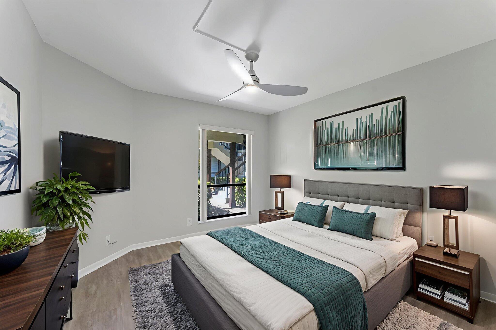 159 Northwest 70th Street, Unit 603 Boca Raton, FL 33487 - Photo 22 of 35 a bedroom with a bed and a flat screen tv