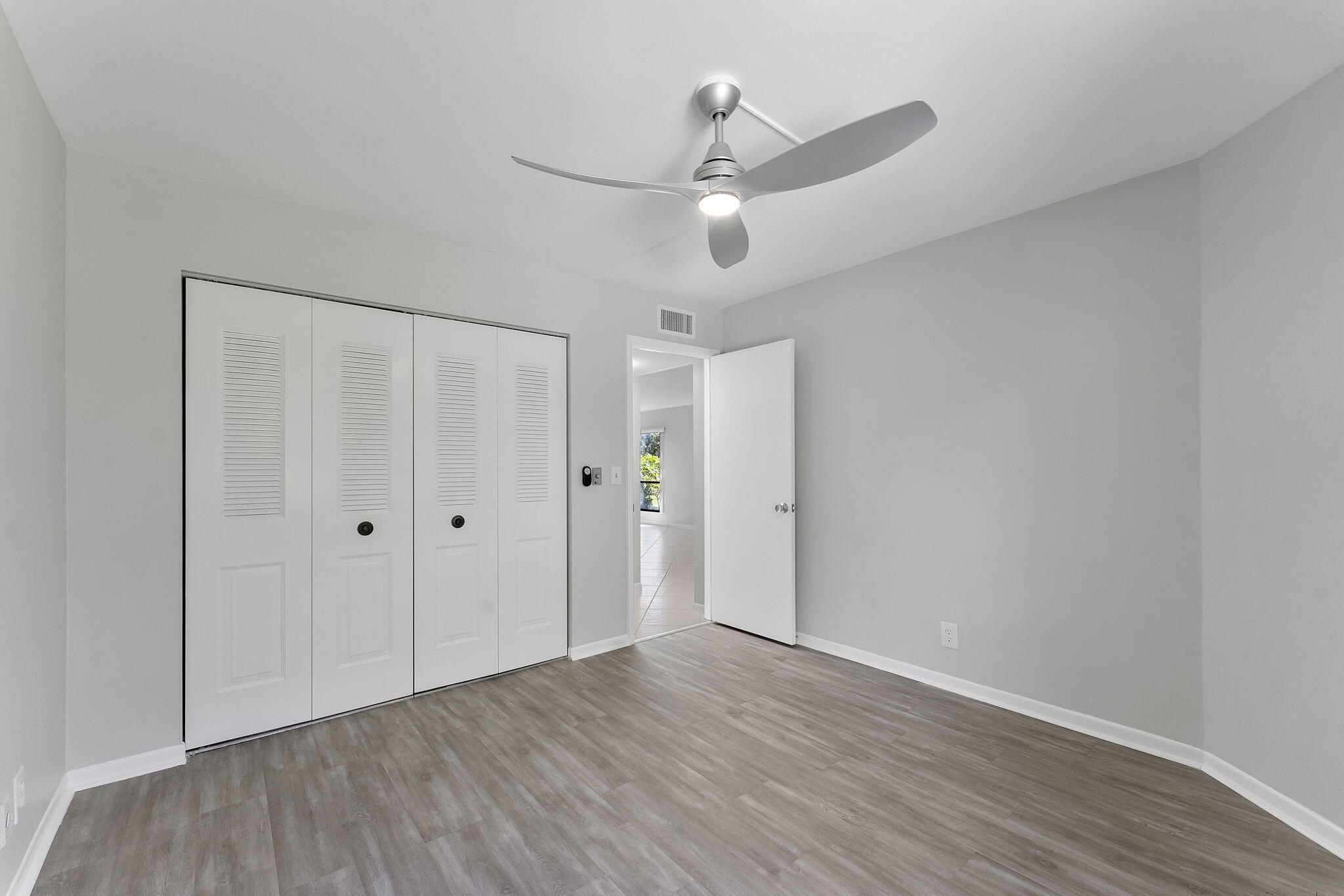 159 Northwest 70th Street, Unit 603 Boca Raton, FL 33487 - Photo 23 of 35 a view of an empty room with wooden floor