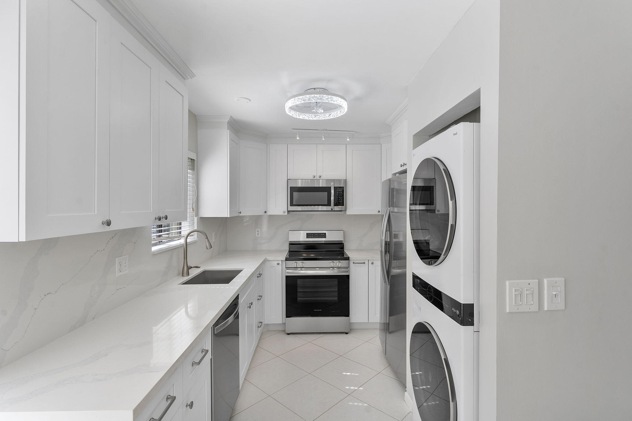 159 Northwest 70th Street, Unit 603 Boca Raton, FL 33487 - Photo 5 of 35 a kitchen with a washer and dryer