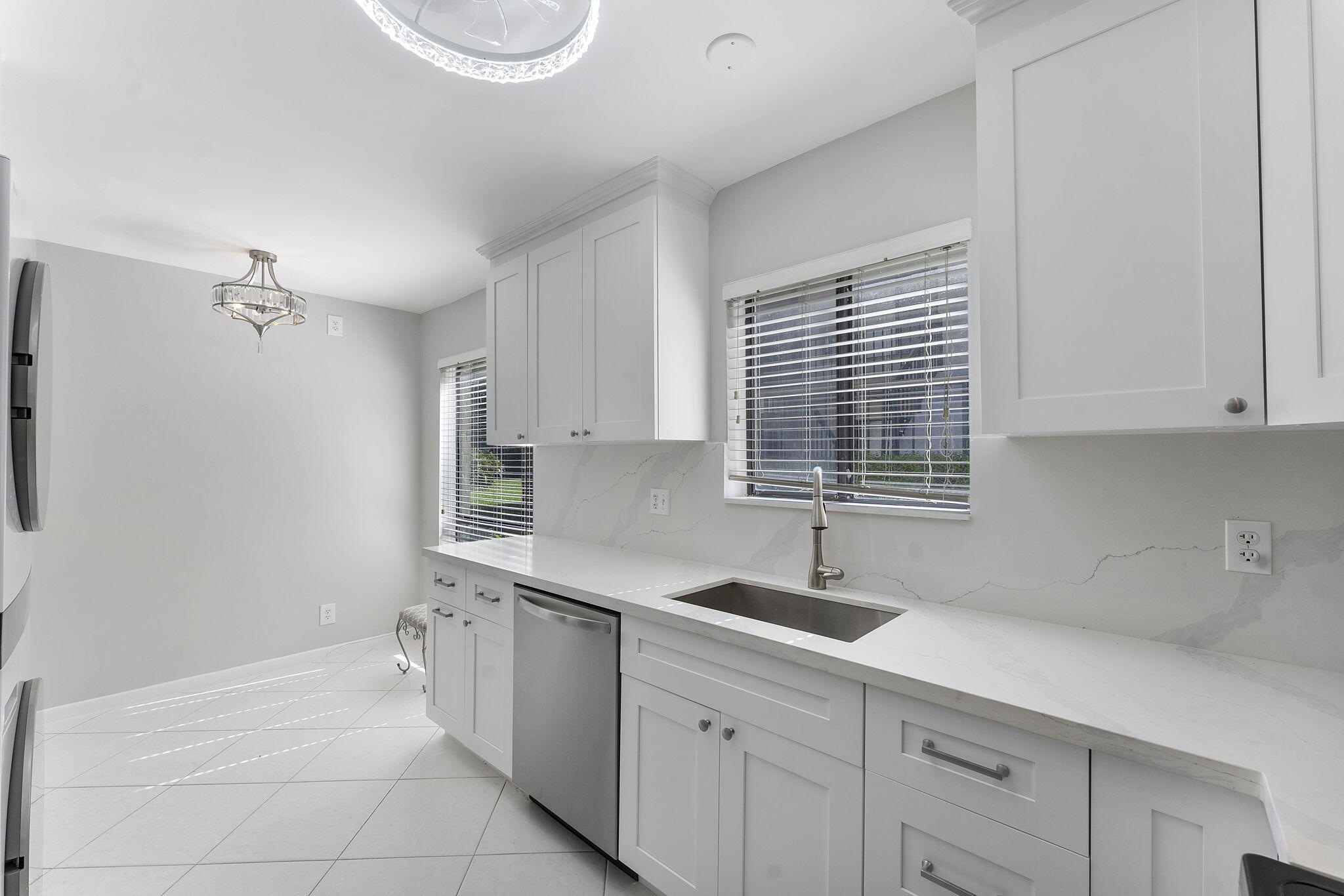 159 Northwest 70th Street, Unit 603 Boca Raton, FL 33487 - Photo 6 of 35 a kitchen with a sink cabinets and window